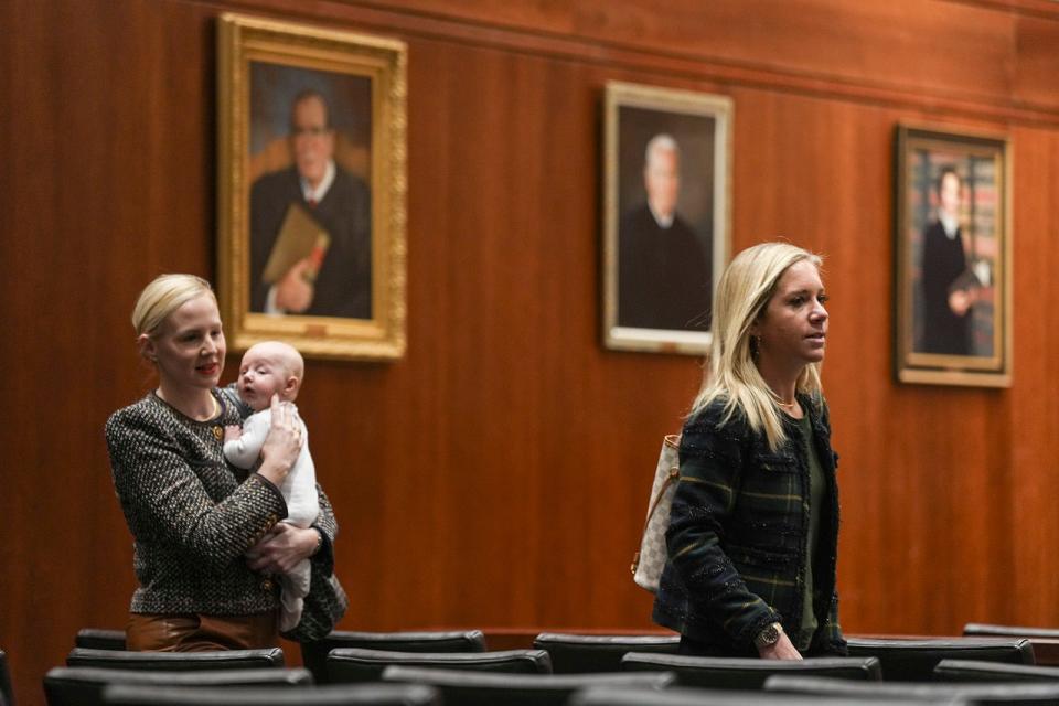 Plaintiffs Amanda Zurawski, right, and Dr. Austin Dennard enter the courtroom Tuesday for the Texas Supreme Court's hearing in Zurawski v. State of Texas. The plaintiffs, 20 women who were denied abortions despite severe pregnancy complications and two OB-GYNs suing on behalf of their patients, are demanding that the state clarify medical exceptions to its near-total abortion ban.