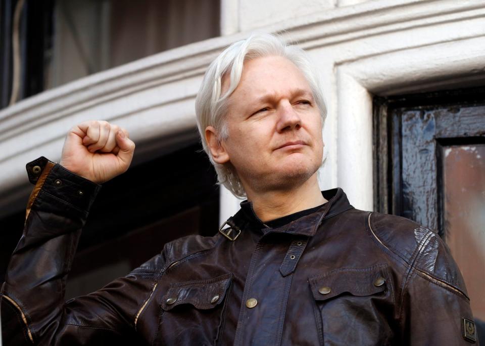 Julian Assange greets supporters outside the Ecuadorian embassy in London - where he remained for seven years while fighting extradition to Sweden and US (AP)