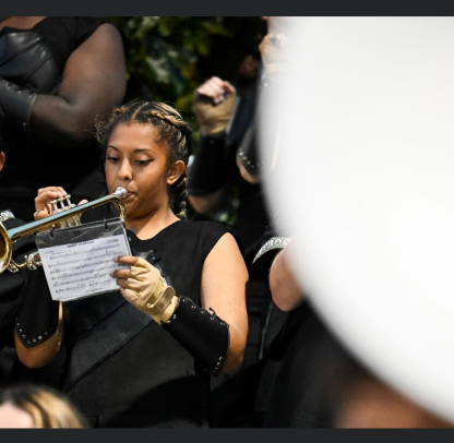 Drea Tutt playing in the school band during an NFA football game. Tutt started a fundraiser for music education at Norwich Public Schools in response to a budget crunch leading to three music teachers, among others, losing their jobs at the end of the year.