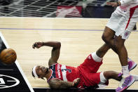 Washington Wizards guard Bradley Beal falls and loses the ball while under pressure from Los Angeles Clippers forward Marcus Morris Sr. during the second half of an NBA basketball game Tuesday, Feb. 23, 2021, in Los Angeles. The Clippers won 135-116. (AP Photo/Mark J. Terrill)