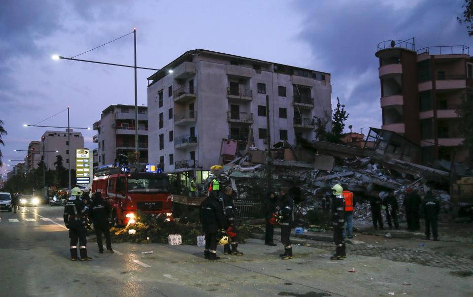 Rescuers search a damaged building in Durres, western Albania, Wednesday, Nov. 27, 2019. The death toll from a powerful earthquake in Albania has risen to 25 overnight as local and international rescue crews continue to search collapsed buildings for survivors. (AP Photo/Visar Kryeziu)