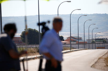 Journalists wait outside the prison where two of the five men cleared of gang rape of a teenager and convicted of a lesser crime of sexual abuse are due to leave jail after being granted provisional release in Alcala de Henares, near Madrid, Spain, June 22, 2018. REUTERS/Javier Barbancho