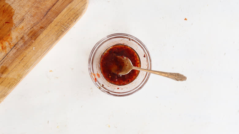 chipotles and honey in a bowl with metal spoon