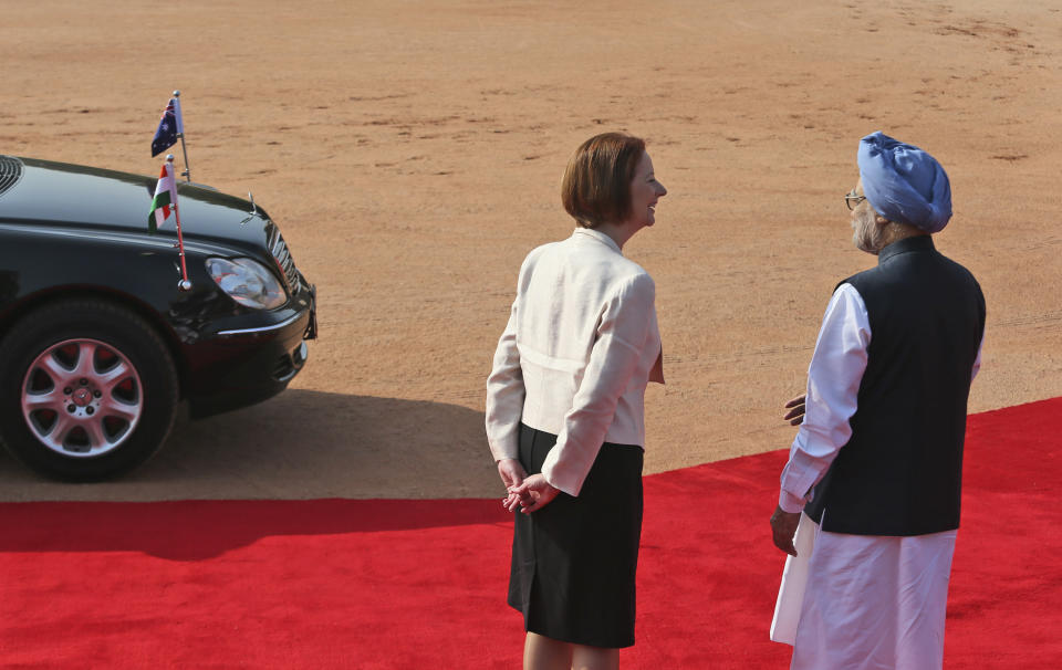 Indian Prime Minister Manmohan Singh, right, talks with his Australian counterpart Julia Gillard on her arrival at the Indian Presidential palace for ceremonial reception, in New Delhi, India , Wednesday, Oct. 17, 2012. (AP Photo/ Manish Swarup)