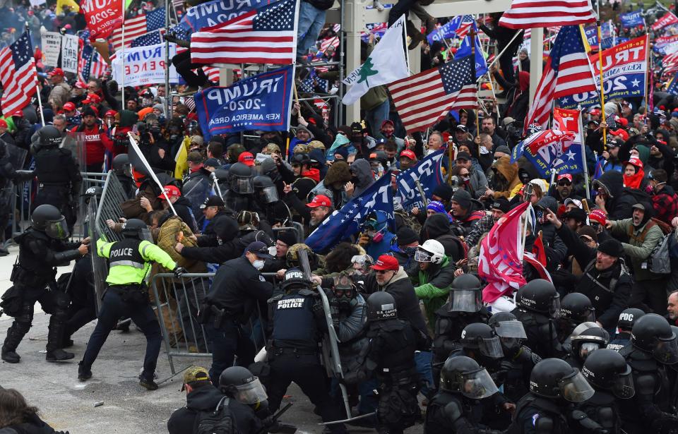 Trump supporters clash with police and security forces as they push barricades to storm the US Capitol in Washington D.C on January 6, 2021. (Roberto Schmidt/AFP via Getty Images)