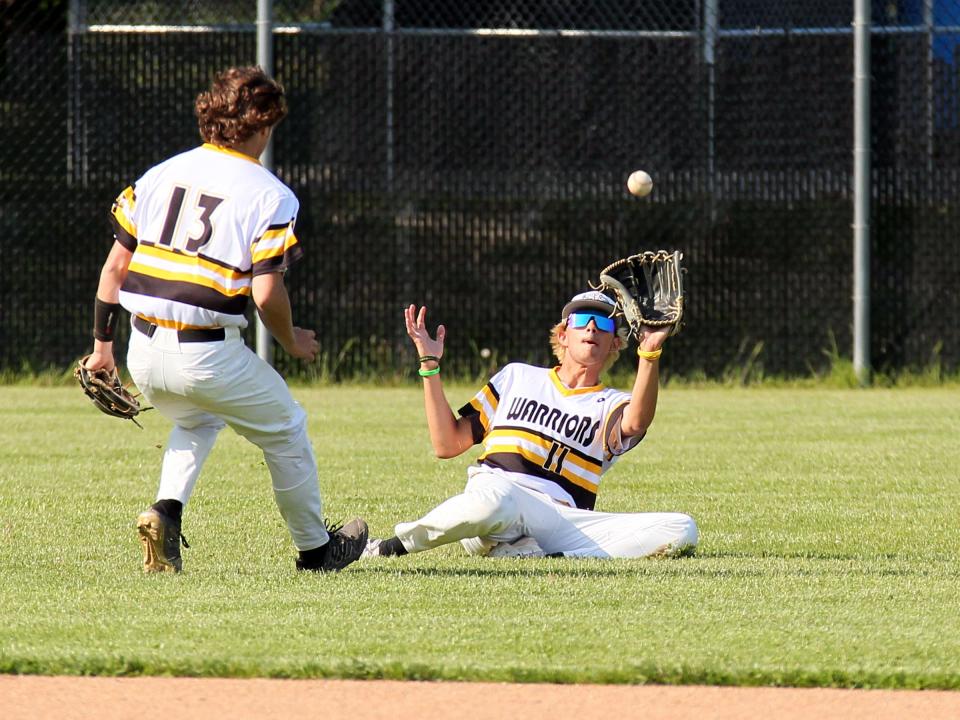 Watkins Memorial's Braiden Bates slides to make a catch in the Warriors' 3-2 victory against Olentangy on Wednesday.