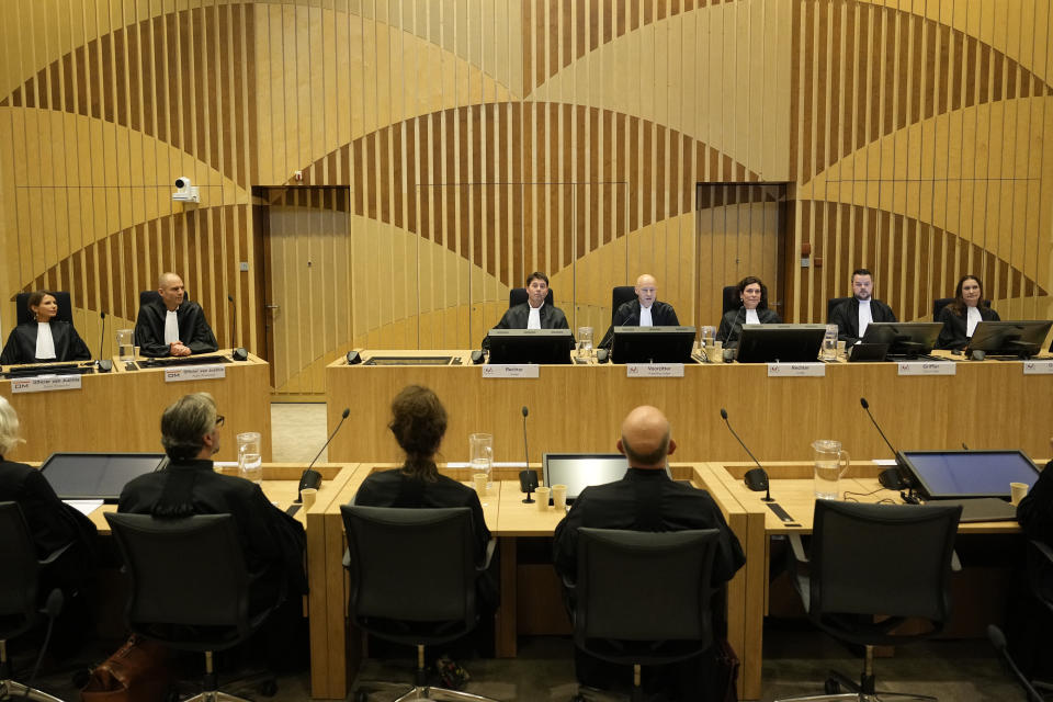 Presiding judge Hendrik Steenhuis, fourth from right, speaks during the verdict session of the Malaysia Airlines Flight 17 trial at the high security court at Schiphol airport, near Amsterdam, Netherlands, Thursday, Nov. 17, 2022. The Hague District Court, sitting at a high-security courtroom at Schiphol Airport, is passing judgment on three Russians and a Ukrainian charged in the downing of Malaysia Airlines flight MH17 over Ukraine and the deaths of all 298 passengers and crew on board, against a backdrop of global geopolitical upheaval caused by Russia's full-blown invasion of Ukraine in February and the nearly nine-month war it triggered. (AP Photo/)