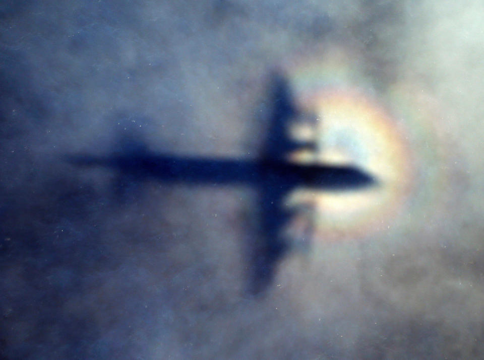 FILE - The shadow of a Royal New Zealand Air Force P3 Orion is seen on low level cloud while the aircraft searches for missing Malaysia Airlines Flight MH370 in the southern Indian Ocean, near the coast of Western Australia, on March 31, 2014. A decade ago this week, a Malaysia Airlines flight vanished without a trace to become one of aviation’s biggest mystery. Investigators still do not know exactly what happened to the plane and its 239 passengers. (AP Photo/Rob Griffith, File)