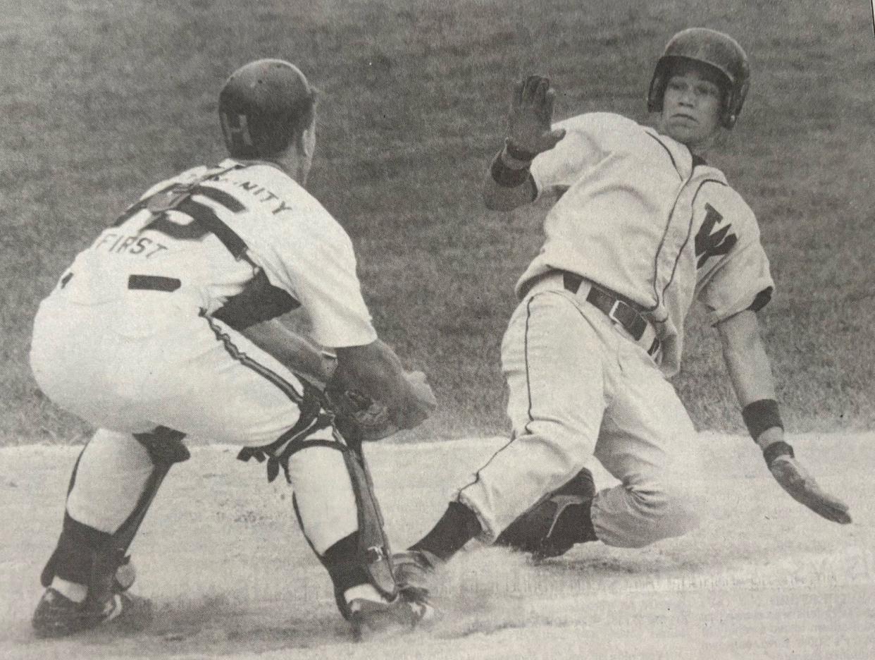 Watertown Post 17 base runner Tim Silliman appears to put up stop sign for Huron catcher Brian Peterson during this play in the 1991 state Class A American Legion Baseball tournament at Watertown Stadium.