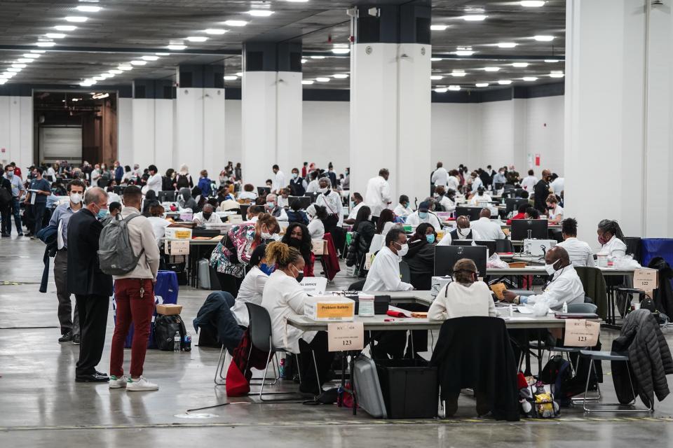 Poll workers count absentee ballots for the city of Detroit at the TCF Center on Nov. 3.