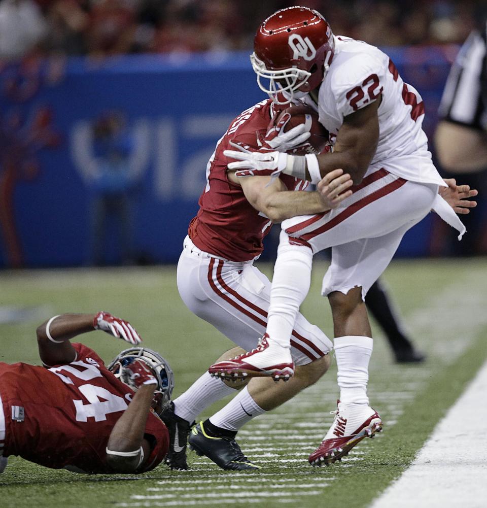 Oklahoma running back Roy Finch (22) is stopped by Alabama linebacker Matt Tinney (43) and defensive back Geno Smith (24) during the second half of the NCAA college football Sugar Bowl in New Orleans, Thursday, Jan. 2, 2014. (AP Photo/Patrick Semansky)