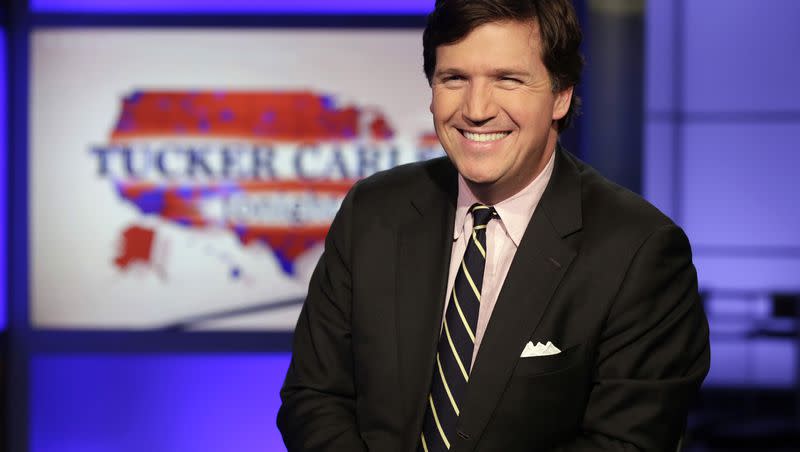 In this file photo, Tucker Carlson poses on the set of “Tucker Carlson Tonight” at a Fox News studio in New York.