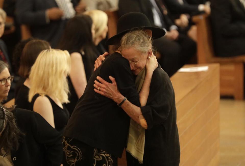 Kathy Riordan, in hat, daughter of Los Angeles Mayor Richard J. Riordan, receives a hug