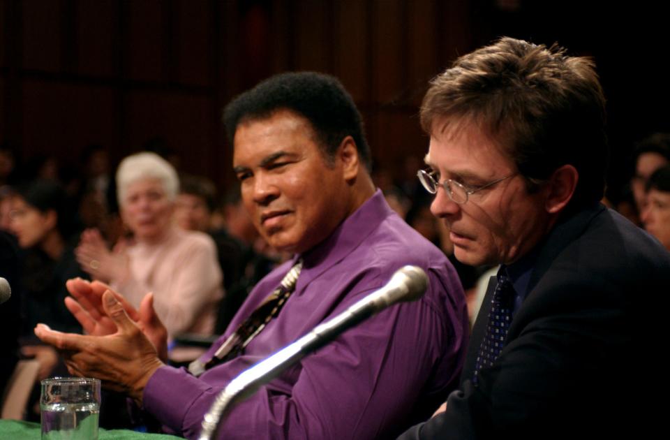 Muhammad Ali and Michael J. Fox attend Congressional hearing in May 2002.