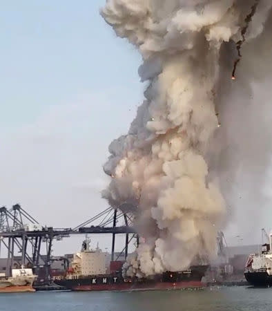 Smoke and debris erupts from a KMTC cargo ship after it caught on fire at the Laem Chabang port, Chonburi province, Thailand May 25, 2019 in this still image take from social media video. Mbah Ambyah via REUTERS