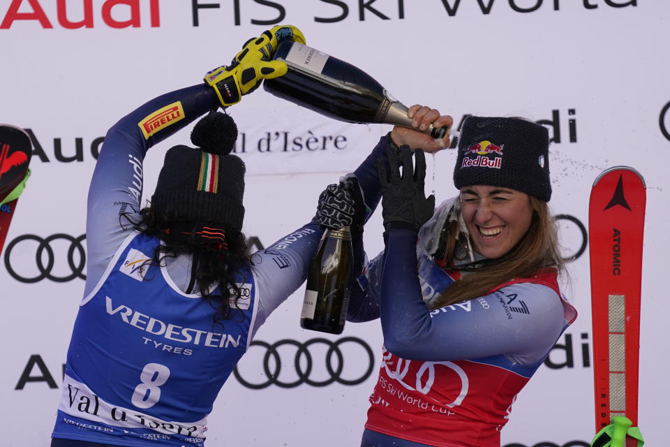 The winner Italy's Federica Brignone and third placed Italy's Sofia Goggia celebrate after an alpine ski, women's World Cup Super G race, in Val d'Isere, France, Sunday, Dec. 17, 2023. (AP Photo/Giovanni Auletta)