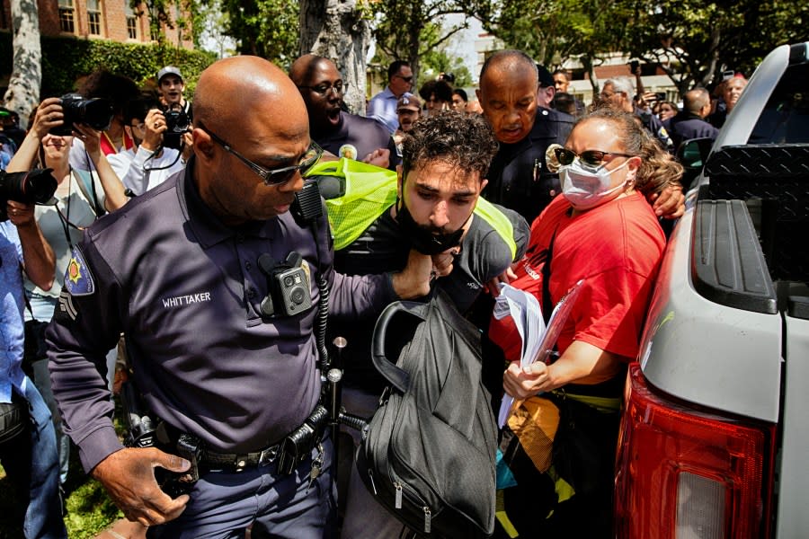 A University of Southern California protester is detained by USC Department of Public Safety officers during a pro-Palestinian occupation at the campus’ Alumni Park on Wednesday, April 24, 2024, in Los Angeles. (AP Photo/Richard Vogel)