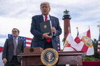 President Donald Trump shows off an executive order on protecting Florida coastline from offshore drilling after delivering remarks on the environment at Jupiter Inlet Lighthouse and Museum, Tuesday, Sept. 8, 2020, in Jupiter, Fla. (AP Photo/Evan Vucci)