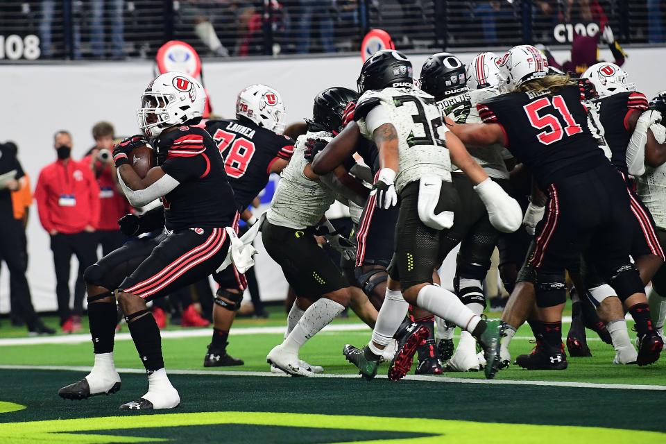 Utah running back Tavion Thomas (9) runs the ball in for a touchdown against Oregon during the first half of the Pac-12 championship game.