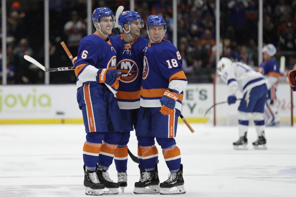 New York Islanders' Ryan Pulock (6) celebrates with teammates Anthony Beauvillier (18) and Derick Brassard after scoring a goal during the second period of the team's NHL hockey game against the Tampa Bay Lightning on Friday, Nov. 1, 2019, in Uniondale, N.Y. (AP Photo/Frank Franklin II)