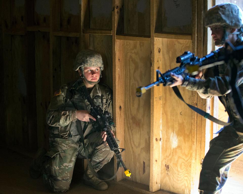 In this Oct. 4, 2017, photo, U.S. Army recruit Kirsten practices building clearing tactics with male recruits at Ft. Benning, Ga. She is one of a handful of women training to become infantry soldiers. The Army’s introduction of women into the infantry has moved steadily but cautiously this year. As home to the previously all-male infantry and armor schools, Fort Benning had to make a number of adjustments, including female dorm rooms, security cameras, monitoring stations. (AP Photo/John Bazemore) ORG XMIT: WX103