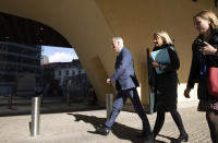 European Union chief Brexit negotiator Michel Barnier, left, walks to an EU General Affairs ministers from EU headquarters in Brussels, Tuesday, Feb. 25, 2020. European Union ministers are putting the final touches on the mandate that will be the guide for EU negotiator Michel Barnier as he sits own with UK officials to thrash out a free trade deal over the next ten months. (AP Photo/Virginia Mayo)