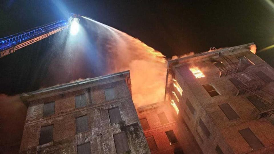 Firefighters work to douse flames from the top floor of the Hotel Marysville, which ignited Saturday, June 15, 2024, and burned through the night as crews worked against flames and the vacant landmark’s structural integrity.