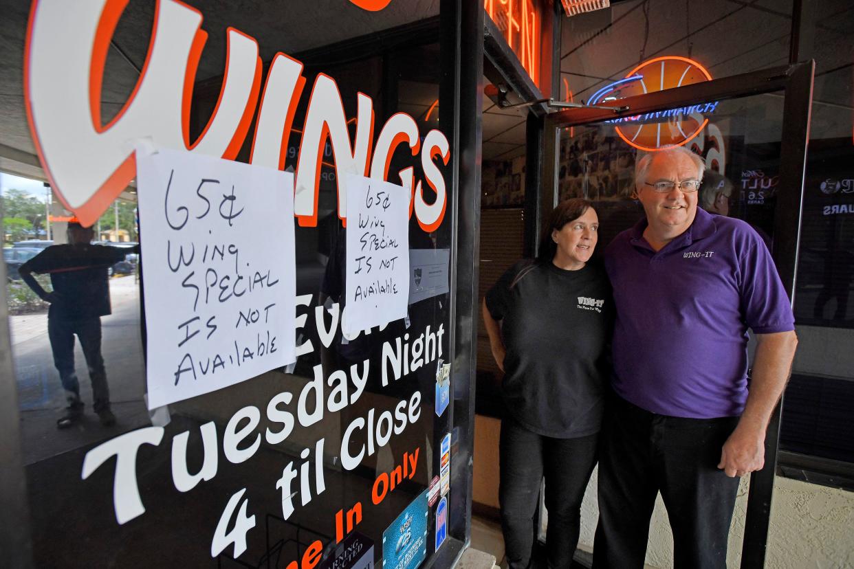 Charleen and her husband Dave Morency at the front door of Wing-It. After 25 years, the couple is reluctantly closing the popular Mandarin bar and grill and wing restaurant.