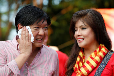 Philippines Vice-President candidate BongBong Marcos talks to his sister Ilocos Norte Governor Imee Marcos during BongBong's announcement of his candidacy in Manila Philippines October 10, 2015. REUTERS/Erik De Castro