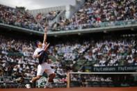 Kei Nishikori of Japan serves to Jo-Wilfried Tsonga of France during their men's quarter-final match during the French Open tennis tournament at the Roland Garros stadium in Paris, France, June 2, 2015. REUTERS/Jean-Paul Pelissier