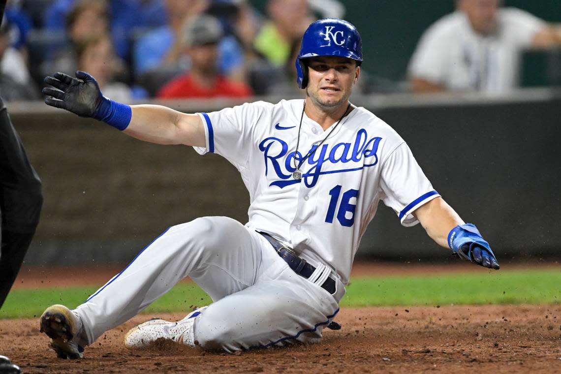 Kansas City Royals’ Andrew Benintendi slides across home plate to score against the Detroit Tigers during the eighth inning of a baseball game, Tuesday, July 12, 2022, in Kansas City, Mo. (AP Photo/Reed Hoffmann)