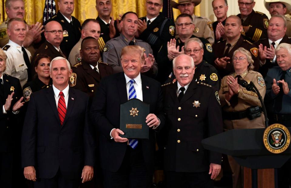 At a White House event in 2018, President Donald Trump posed for a photos with Vice President Mike Pence and Bristol County Sheriff Thomas Hodgson (at right).