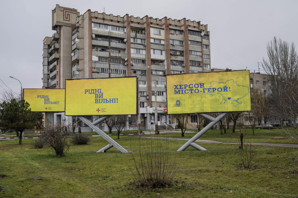 Newly placed Ukrainian billboard in Kherson, southern Ukraine, Nov. 27, 2022. From left, the billboard reads in Ukrainian: "Dear, you are Free" and "Kherson, Hero City". (AP Photo/Bernat Armangue)