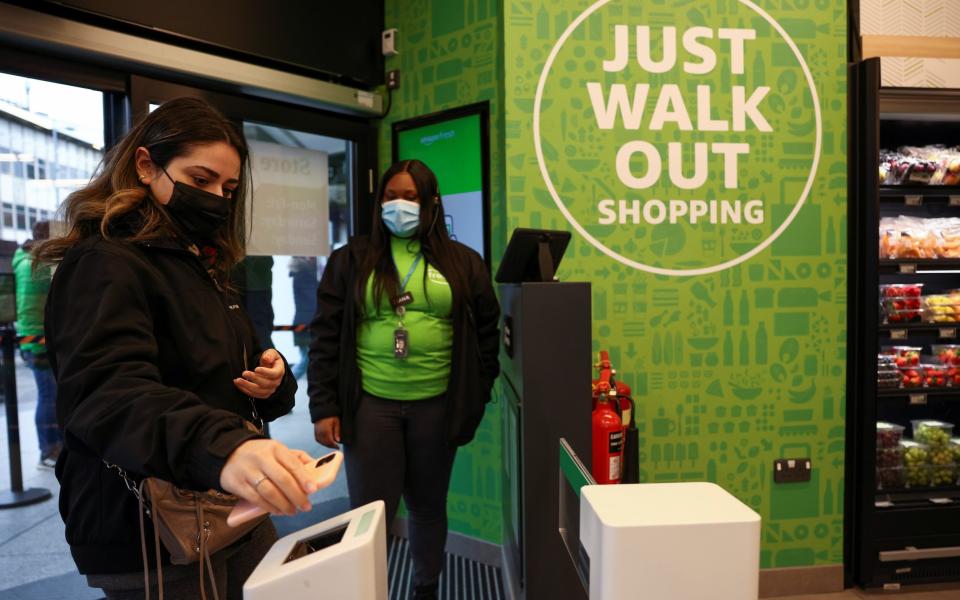 A customer scans a QR code to enter at the UK's first Amazon Fresh supermarket in London - REUTERS /HENRY NICHOLLS 