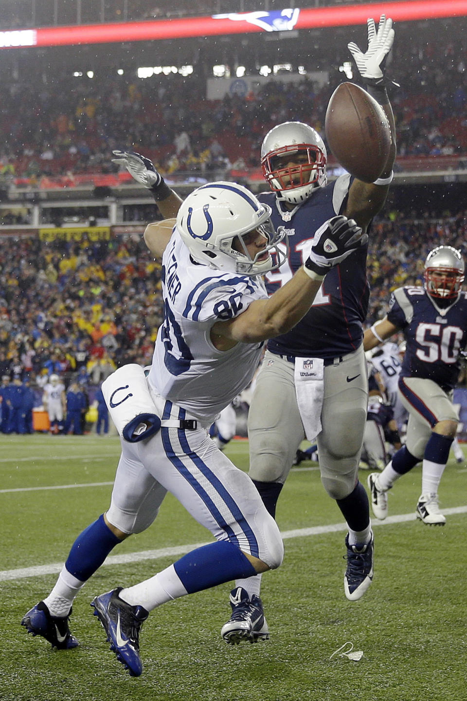 A pass gets away from Indianapolis Colts tight end Coby Fleener (80) under pressure from New England Patriots linebacker Jamie Collins (91) during the second half of an AFC divisional NFL playoff football game in Foxborough, Mass., Saturday, Jan. 11, 2014. (AP Photo/Matt Slocum)