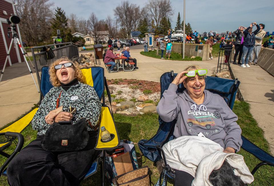 Virginia Walter, 80, of Farmington, watches the solar eclipse with her “forever friend” Kathlaine O’Connor, 79, of New Boston, at the public beach In Luna Pier on Monday, April 8, 2024. Walter says O’Connor called her and said she had booked a hotel in Luna Pier and asked whether she wanted to watch the eclipse with her. “We are having such a good time!”