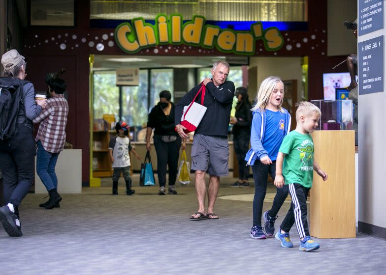 Huntington Beach, CA - May 01: Bruce Growth takes his grandchildren Logan and Juliana Weber to the HuntingtoN Beach Public Library on Monday, May 1, 2023. (Scott Smeltzer / Daily Pilot)