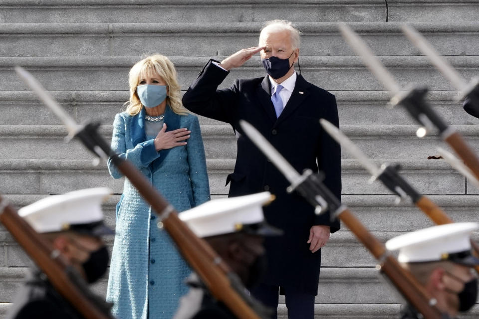 President Joe Biden and his wife Jill Biden watch a military pass in review ceremony on the East Front of the Capitol at the conclusion of the inauguration ceremonies, in Washington, Wednesday, Jan. 20, 2021. (AP Photo/J. Scott Applewhite)