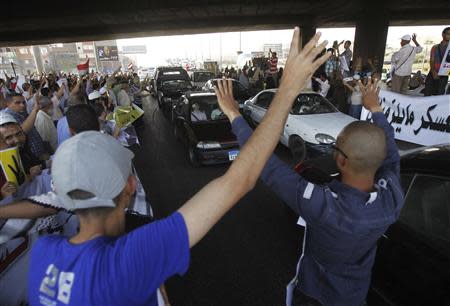 Members of the Muslim Brotherhood and supporters of ousted Egyptian President Mohamed Mursi protest against the military and interior ministry, as they show the "Rabaa" or "four" gesture, in reference to the police clearing of Rabaa al-Adawiya protest camp on August 14, along a highway in the southern suburb of Maadi September 3, 2013. REUTERS/Amr Abdallah Dalsh