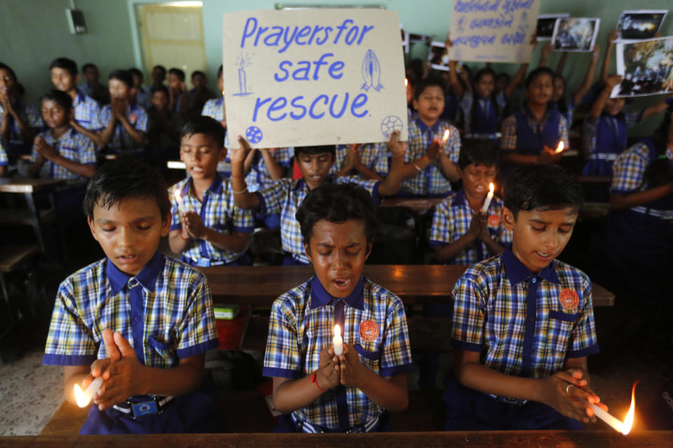 Indian students hold candles and pray for boys and their soccer coach who have been trapped since June 23. Source: AP