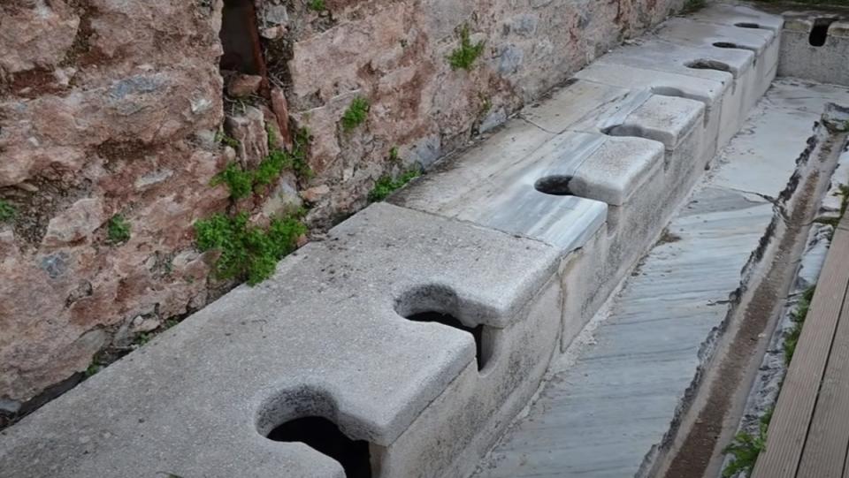 The ruins of an ancient Roman latrine, the likes of which are explored in a new video that takes a look at the facilities' gross and amazing functionality.