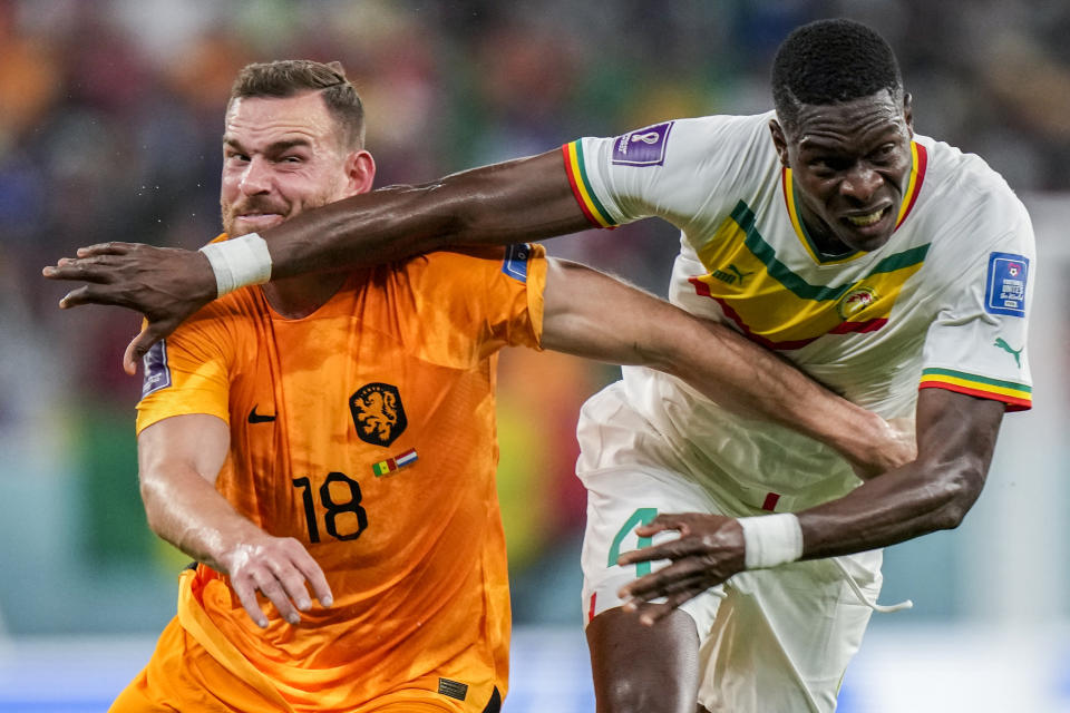 Vincent Janssen of the Netherlands, left, fights for the ball with Senegal's Pape Abou Cisse during the World Cup, group A soccer match between Senegal and Netherlands at the Al Thumama Stadium in Doha, Qatar, Monday, Nov. 21, 2022. (AP Photo/Luca Bruno)