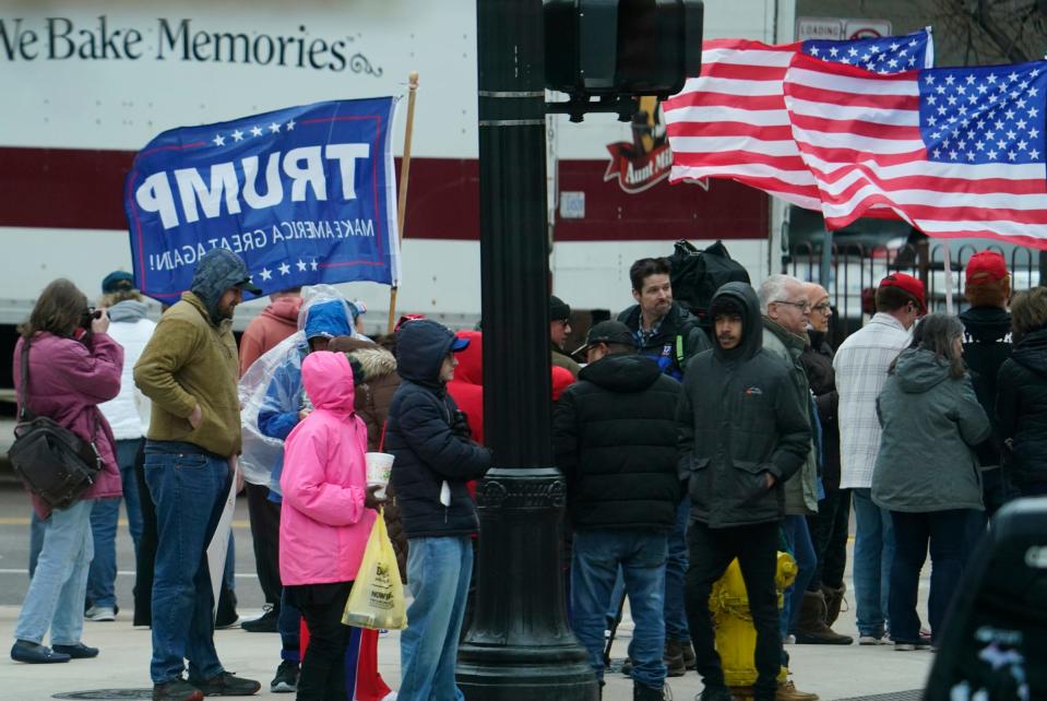 Supporters stand across the street from DeVos Place before Donald Trump speaks at a press conference in the Monroe Meeting Rooms at DeVos Place in Grand Rapids on Tuesday, April 2, 2024.