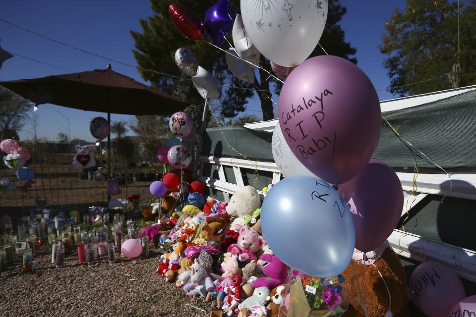 A makeshift memorial grows in front of the home where Rachel Henry was arrested on suspicion of killing her three children after they were found dead inside the family home earlier in the week, shown here Thursday, Jan. 23, 2020, in Phoenix. (AP Photo/Ross D. Franklin)