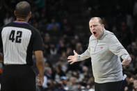 New York Knicks coach Tom Thibodeau yells at referee Eric Lewis during the first half of the team's NBA basketball game against the San Antonio Spurs, Tuesday, Dec. 7, 2021, in San Antonio. (AP Photo/Darren Abate)