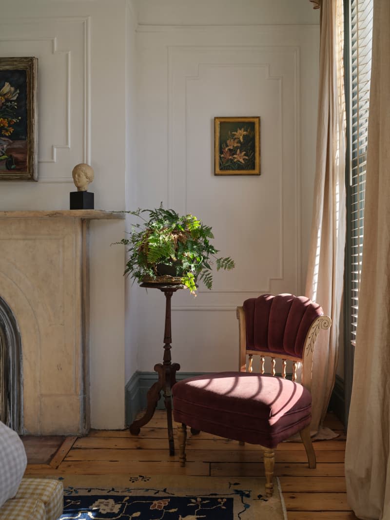Vintage chair in corner of bedroom.