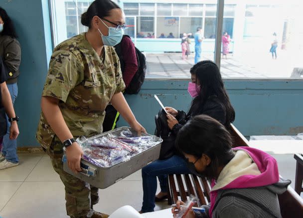 PHOTO: U.S. Army Spc. Danielle Price, left, a dental hygienist with the Health Engagements Assistance Response Team (HEART) 2022, hands toothbrushes to children at Hospital Regional de Occidente in Quetzaltenango, Guatemala, Aug. 24, 2022. (Sgt. 1st Class Shane Placke/U.S. Army)