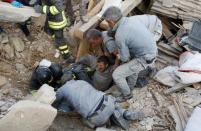 A man is rescued alive from the ruins following an earthquake in Amatrice, central Italy, August 24, 2016. REUTERS/Remo Casilli