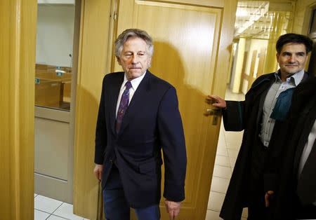 Filmmaker Roman Polanski (C) arrives for a court hearing in Krakow February 25, 2015. Polanski appeared in a Polish court on Wednesday at a hearing to consider a U.S. request for his extradition over a 1977 child sex crime conviction. REUTERS/Kacper Pempel