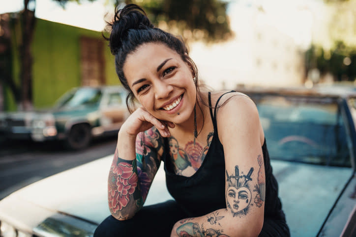 A woman with many tattoos on her arms and chest